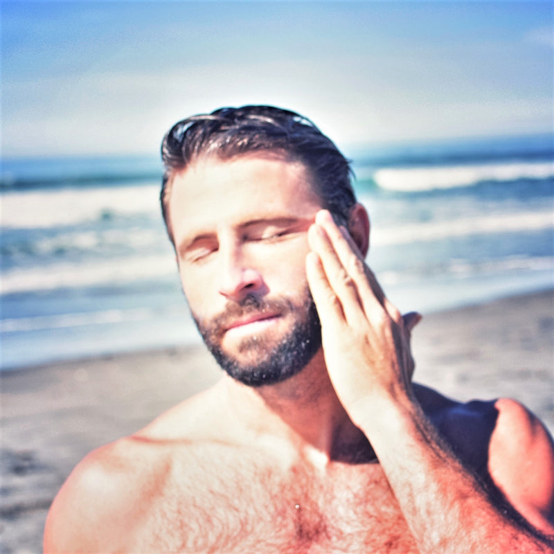 man applying sunscreen
